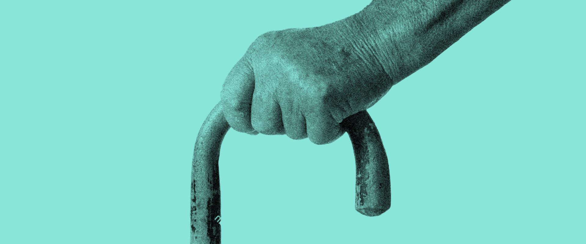 Elderly hand holding walking stick